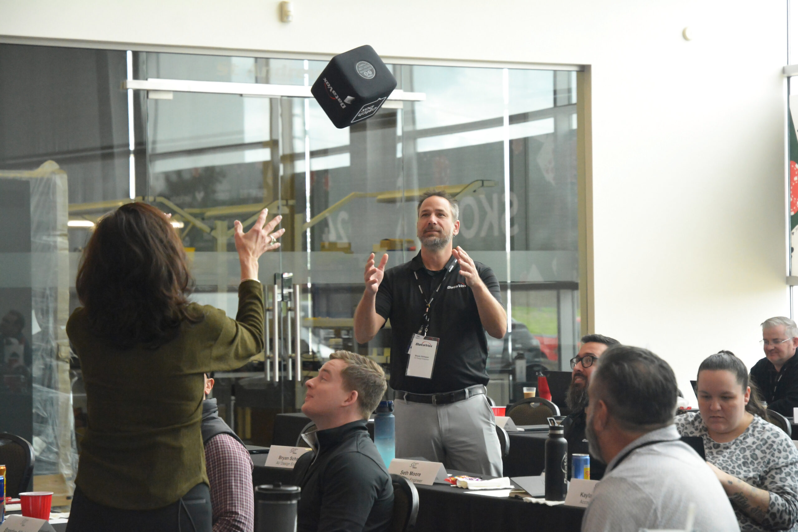 A man about to catch a speakers cube to present his thoughts/ideas.