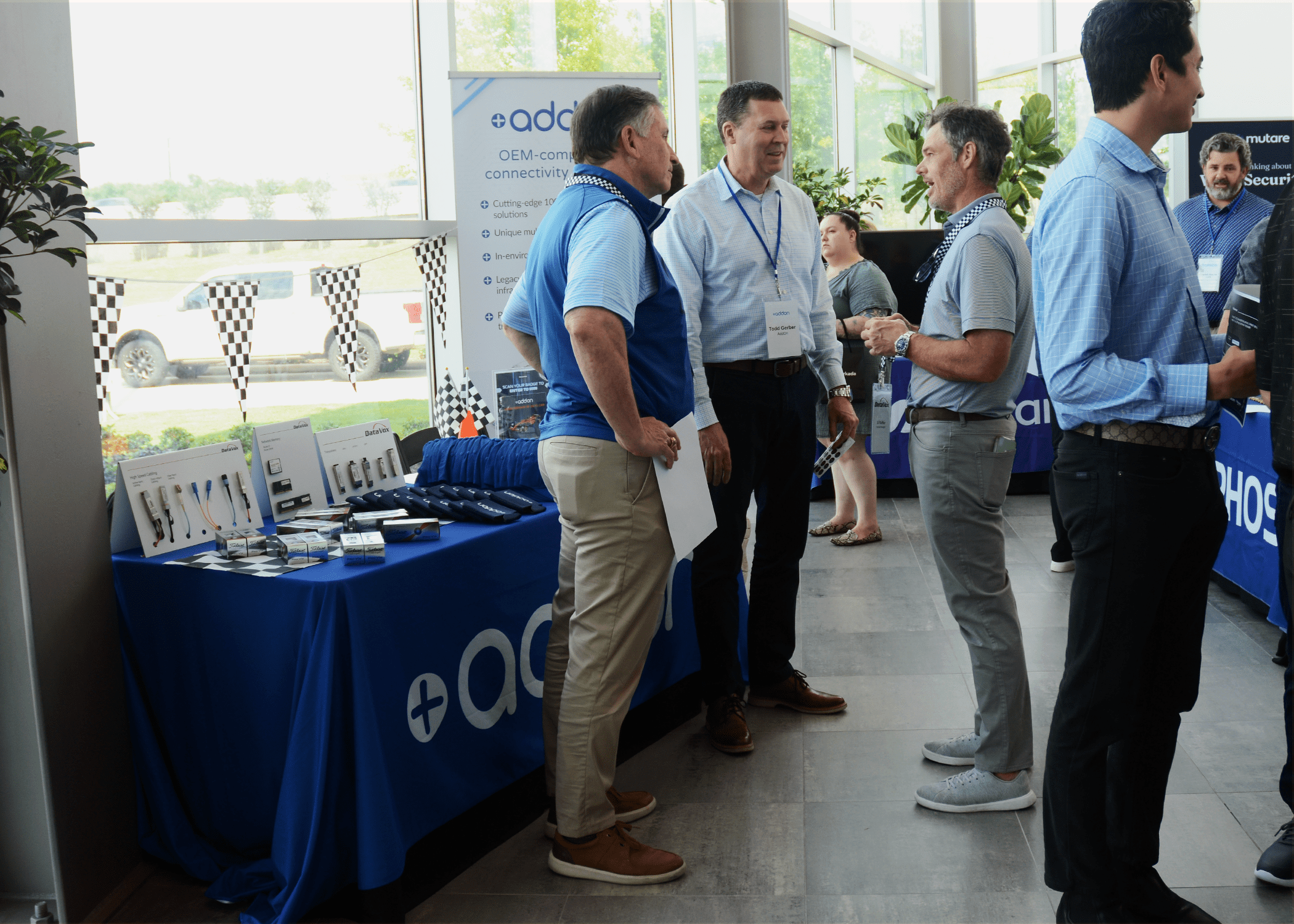 IT Summit attendees speaking to AddOn representatives infront of their booth.