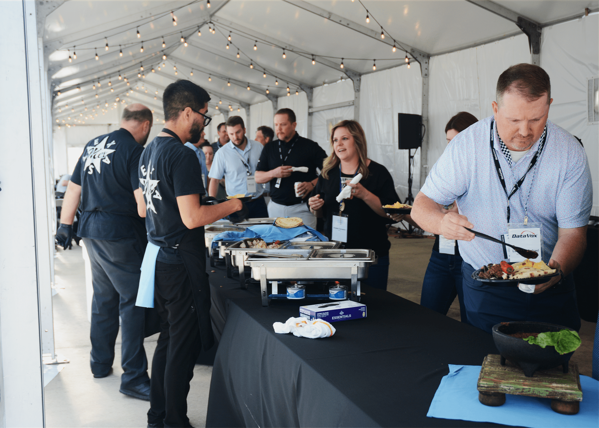 DataVox team members and partners serving themselves food from Lupe Tortilla during the networking reception.
